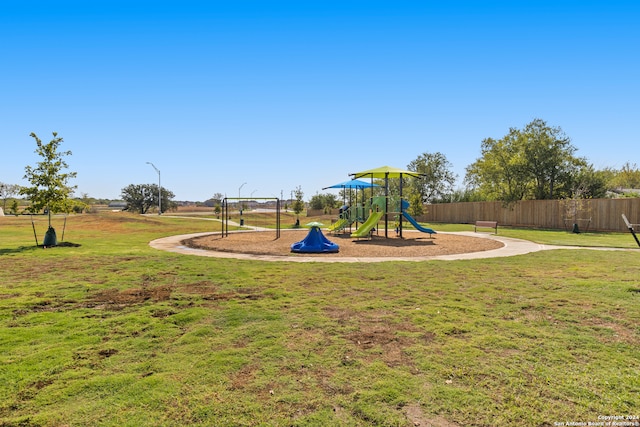 view of jungle gym featuring a lawn