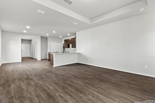 unfurnished living room with dark wood-type flooring