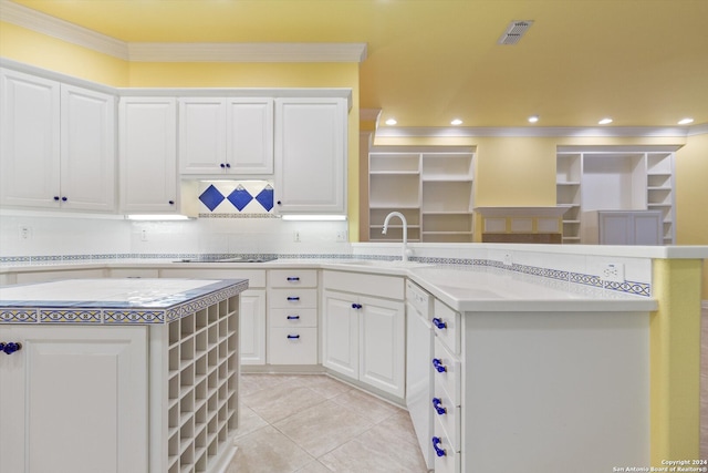 kitchen featuring crown molding, white cabinets, sink, and a kitchen island