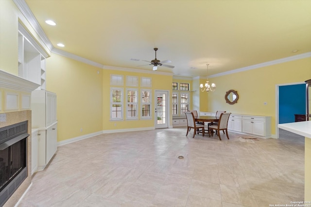 dining area featuring ornamental molding, a fireplace, and ceiling fan with notable chandelier