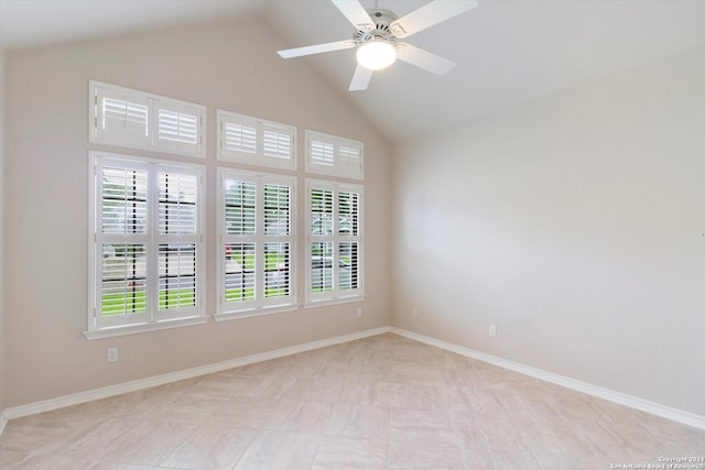 tiled spare room with lofted ceiling and ceiling fan