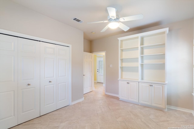 unfurnished bedroom featuring light tile patterned flooring, a closet, and ceiling fan