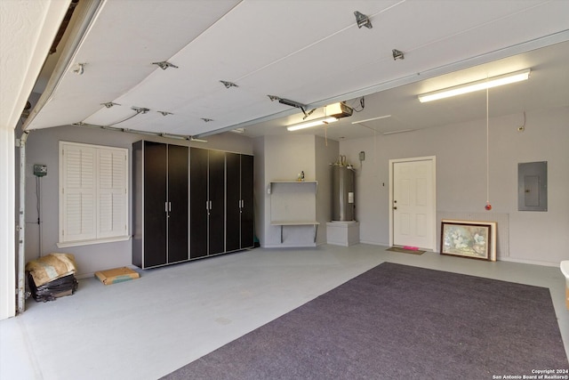 garage featuring a garage door opener, electric water heater, and electric panel