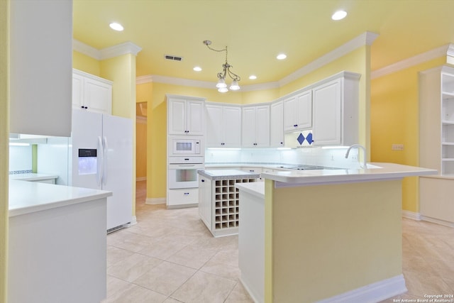 kitchen with white appliances, white cabinetry, ornamental molding, and kitchen peninsula