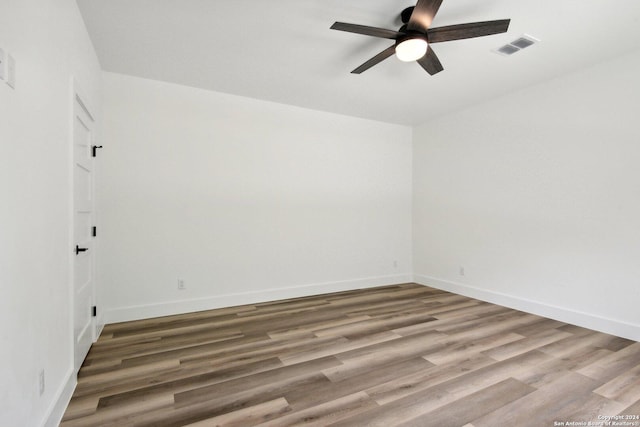 empty room featuring ceiling fan and wood-type flooring