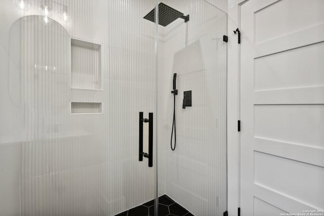 bathroom featuring a shower with shower door