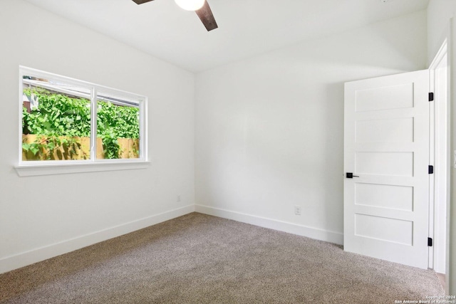 unfurnished room with ceiling fan and carpet