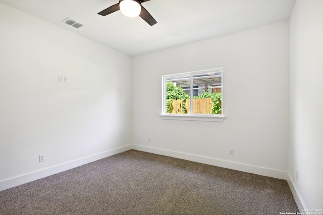 carpeted spare room featuring ceiling fan