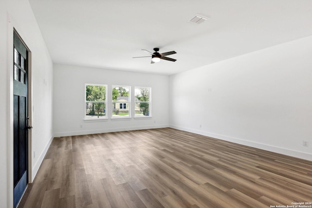 spare room with hardwood / wood-style flooring and ceiling fan