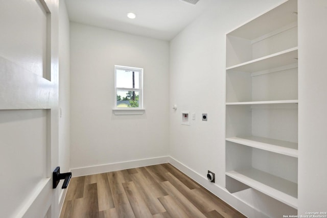 laundry area with electric dryer hookup, hookup for a washing machine, and hardwood / wood-style floors