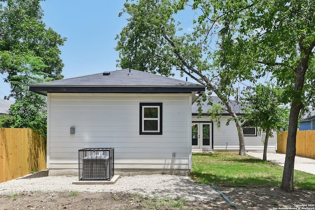 rear view of house with french doors and central AC unit