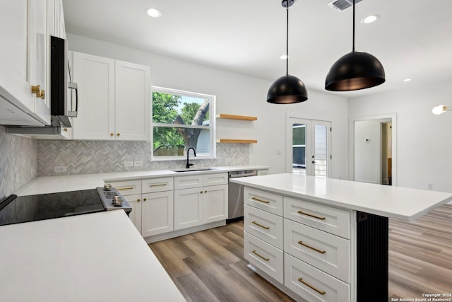 kitchen with dishwasher, pendant lighting, white cabinetry, and sink