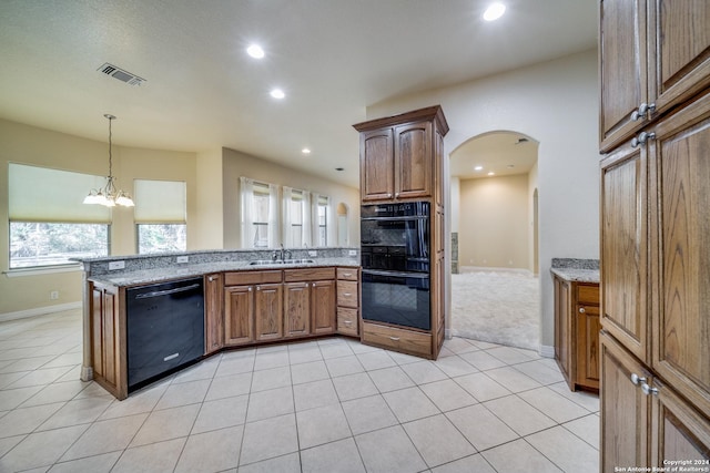 kitchen featuring sink, an inviting chandelier, light stone counters, kitchen peninsula, and black appliances