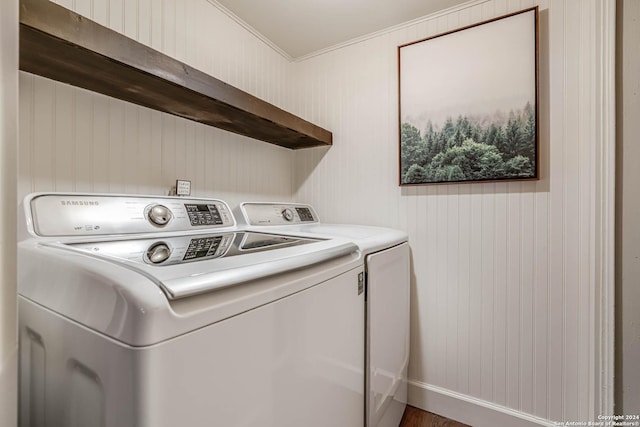 laundry area featuring washing machine and clothes dryer and crown molding