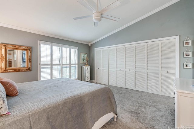 bedroom with carpet, a closet, ornamental molding, vaulted ceiling, and ceiling fan