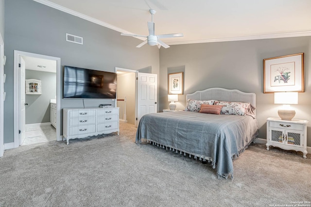 carpeted bedroom with crown molding, high vaulted ceiling, ensuite bath, and ceiling fan