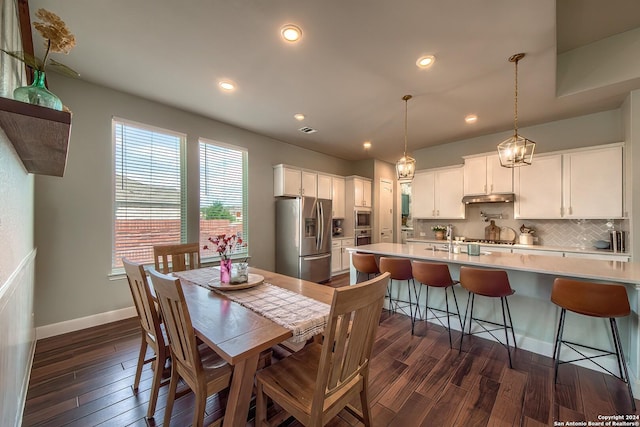 dining space featuring dark hardwood / wood-style flooring and sink