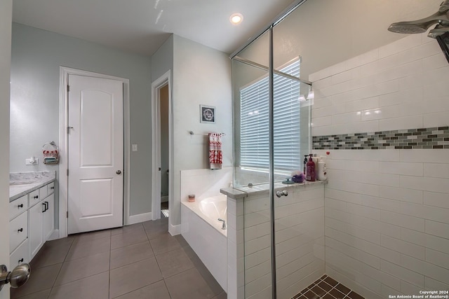 bathroom featuring vanity, tile patterned floors, and plus walk in shower