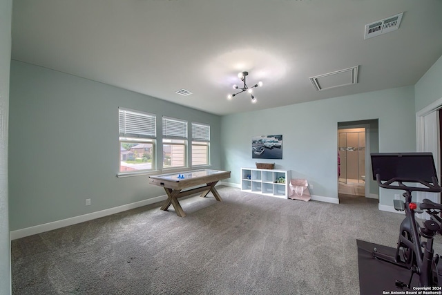 recreation room with carpet floors and an inviting chandelier