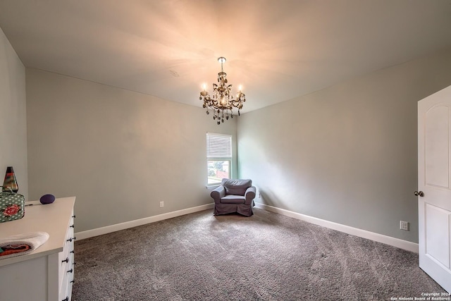 unfurnished room with dark colored carpet and a chandelier