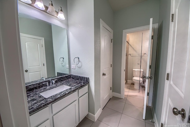 bathroom with toilet, tile patterned floors, and vanity