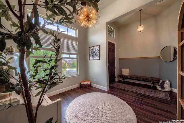 bathroom with a high ceiling and hardwood / wood-style flooring