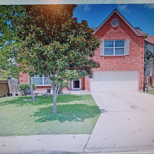 view of front facade with a garage and a front yard