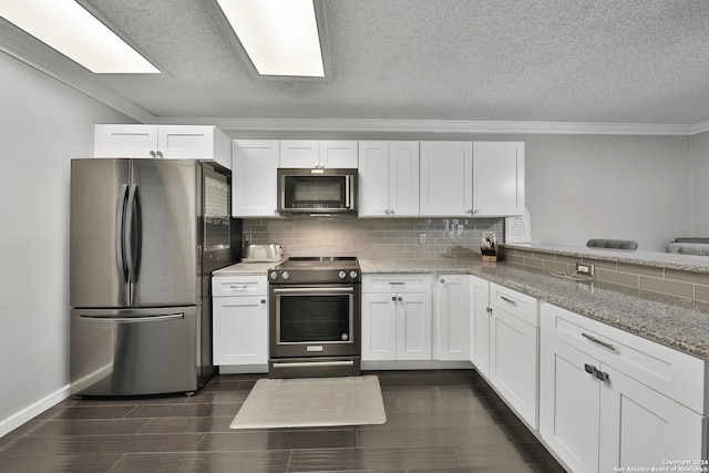 kitchen with white cabinetry, stainless steel appliances, and ornamental molding