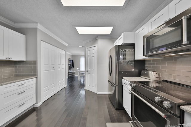 kitchen with backsplash, dark hardwood / wood-style flooring, range with electric cooktop, and a skylight