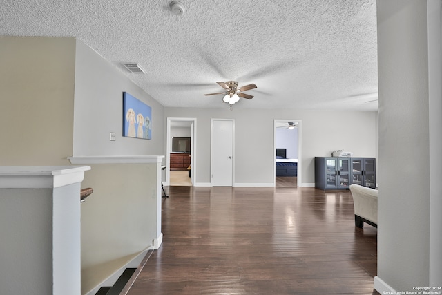 hall featuring dark hardwood / wood-style flooring and a textured ceiling