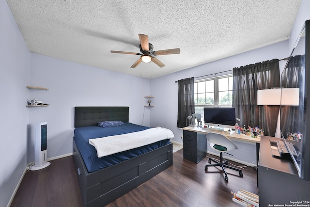 bedroom with ceiling fan, a textured ceiling, and dark hardwood / wood-style flooring