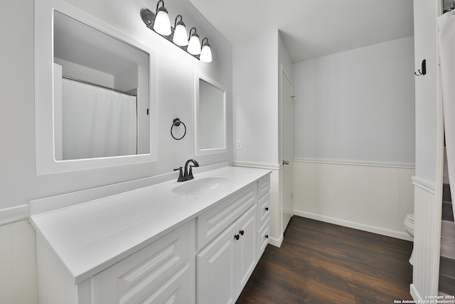 bathroom featuring vanity, toilet, and hardwood / wood-style floors