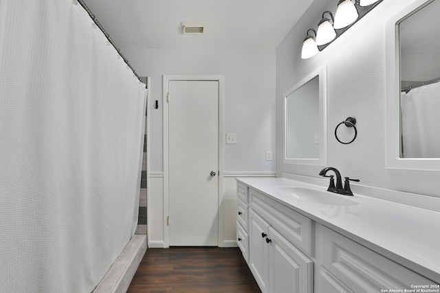 bathroom with vanity and hardwood / wood-style flooring