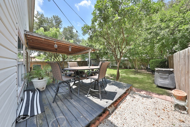 wooden deck featuring a lawn