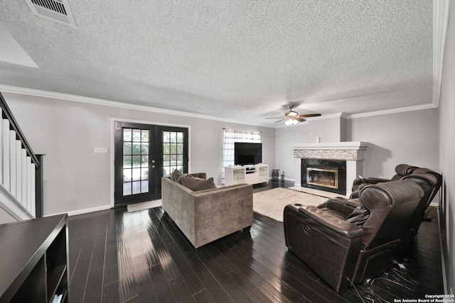 living room with french doors, crown molding, dark hardwood / wood-style floors, a textured ceiling, and ceiling fan