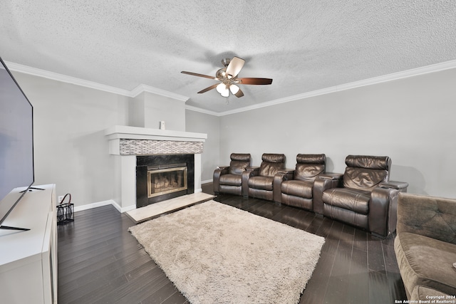 living room with dark wood-type flooring, ornamental molding, a fireplace, and ceiling fan