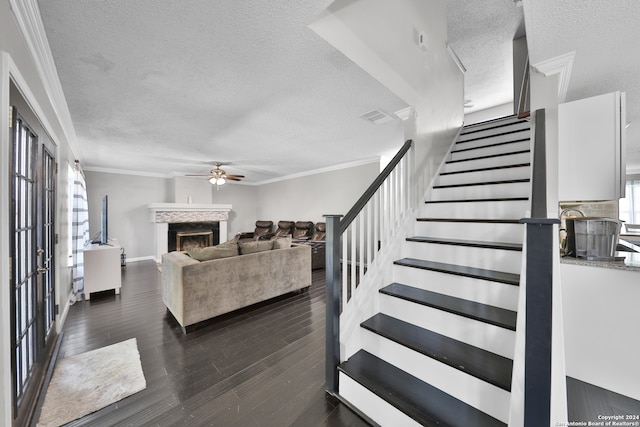 living room featuring dark hardwood / wood-style flooring, crown molding, and ceiling fan