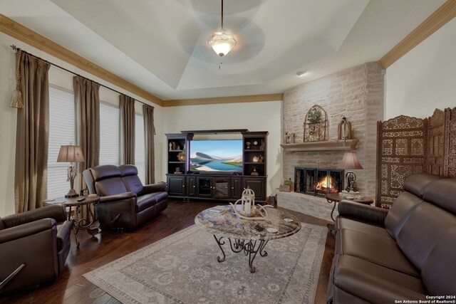 bedroom featuring connected bathroom, crown molding, dark wood-type flooring, ceiling fan, and a raised ceiling