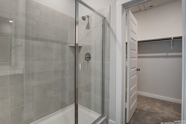 bathroom featuring a shower with shower door