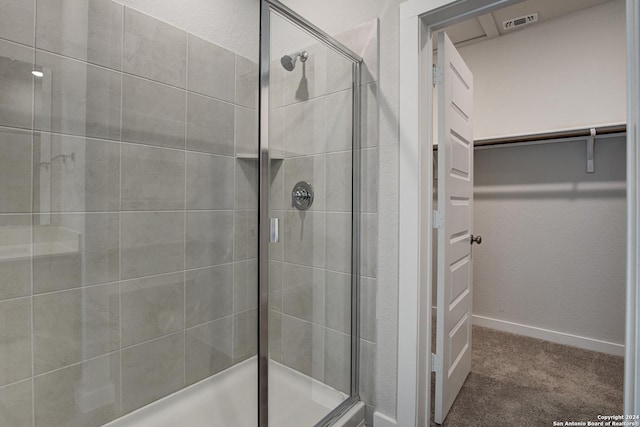 14518 Emerio Dr, San Antonio, TX 78253 - full bathroom featuring visible vents, baseboards, a walk in closet, and a stall shower