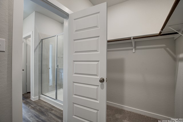 bathroom featuring hardwood / wood-style floors and walk in shower