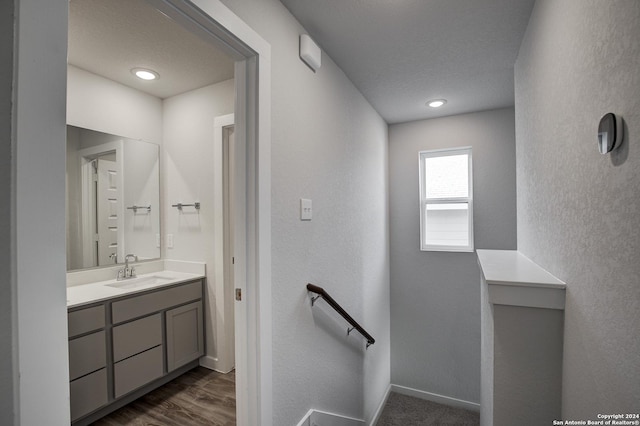 14518 Emerio Dr, San Antonio, TX 78253 - bathroom with baseboards, a textured wall, vanity, and wood finished floors