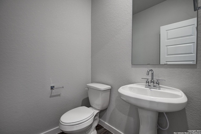 14518 Emerio Dr, San Antonio, TX 78253 - bathroom with toilet, a textured wall, wood finished floors, and baseboards