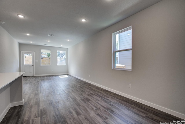 14518 Emerio Dr, San Antonio, TX 78253 - unfurnished living room with visible vents, baseboards, and dark wood-style floors