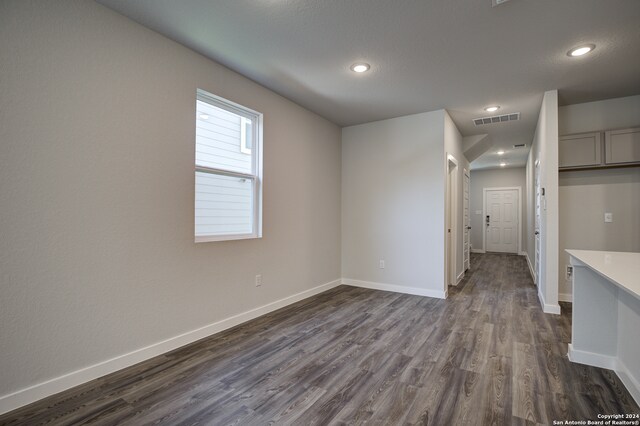 unfurnished room featuring dark wood-type flooring