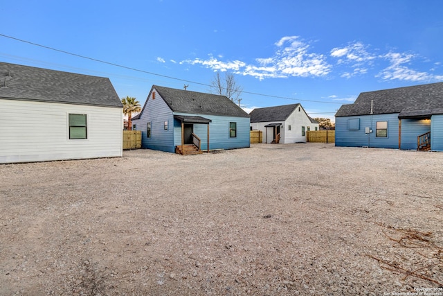 back of house featuring an outbuilding