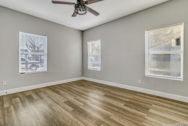 unfurnished room featuring light hardwood / wood-style flooring, ceiling fan, and a healthy amount of sunlight