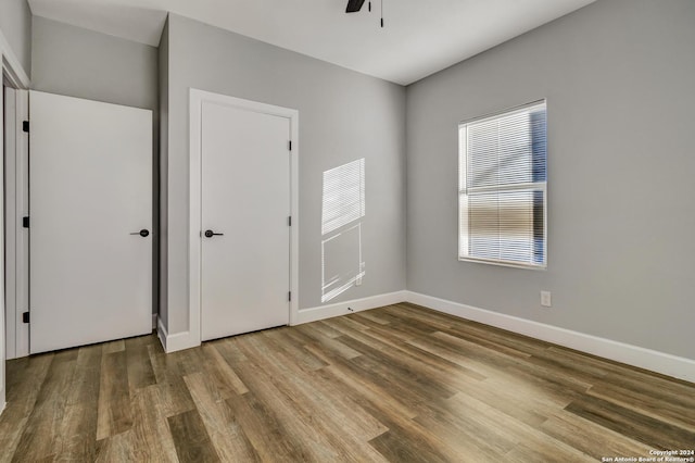 unfurnished bedroom with hardwood / wood-style floors and ceiling fan