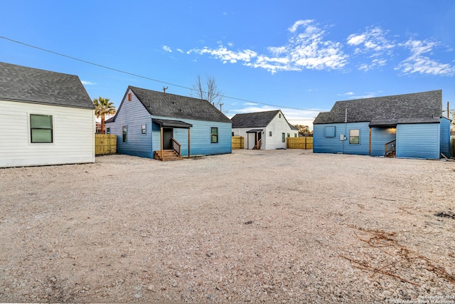 back of property featuring an outdoor structure