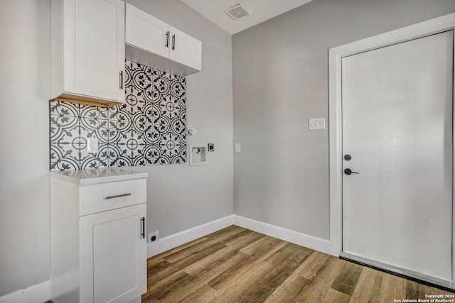 laundry room with hookup for an electric dryer, light hardwood / wood-style floors, and washer hookup